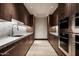 Modern kitchen featuring marble countertops and stainless-steel appliances at 9643 E Cintarosa Pass, Scottsdale, AZ 85262