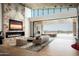 Open-concept living area featuring a modern fireplace, seamless indoor-outdoor transition, and mountain views at 9643 E Cintarosa Pass, Scottsdale, AZ 85262