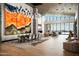 Open-concept living and dining space featuring wood floors, contemporary artwork, and modern lighting at 9643 E Cintarosa Pass, Scottsdale, AZ 85262