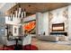 Spacious living and dining area with stone columns, contemporary art, and modern lighting fixtures at 9643 E Cintarosa Pass, Scottsdale, AZ 85262