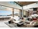 Stylish living room opens to an outdoor patio with an infinity pool and a backdrop of scenic mountain views at 9643 E Cintarosa Pass, Scottsdale, AZ 85262