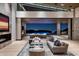 Elegant living room featuring stone accents, a fireplace, and seamless access to outdoor pool at 9643 E Cintarosa Pass, Scottsdale, AZ 85262