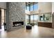 Bright main bathroom with stone fireplace, a soaking tub, and tile floors at 9643 E Cintarosa Pass, Scottsdale, AZ 85262