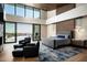 Main bedroom featuring high ceilings, a private deck, a stone fireplace, and hardwood floors at 9643 E Cintarosa Pass, Scottsdale, AZ 85262