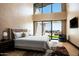 Spacious main bedroom with large windows, neutral decor, and elegant furnishings at 9643 E Cintarosa Pass, Scottsdale, AZ 85262