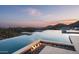 Enjoy the pool, fire feature, and scenic mountain vistas from this modern outdoor space at 9643 E Cintarosa Pass, Scottsdale, AZ 85262