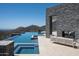 Tranquil pool, outdoor fireplace and lounge space offer luxurious relaxation with scenic mountain views at 9643 E Cintarosa Pass, Scottsdale, AZ 85262