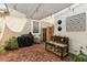 Outdoor living space with a brick patio, shade sail, string lights, and outdoor kitchen area at 10220 E Isleta Ave, Mesa, AZ 85209