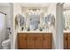 Spacious bathroom with a double sink vanity, ample lighting, and a large mirror for a luxurious feel at 10220 E Isleta Ave, Mesa, AZ 85209