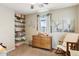 Bedroom with dresser and rocking chair. Adorable decor on shelves at 10220 E Isleta Ave, Mesa, AZ 85209