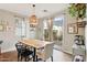 Inviting dining area with a large wooden table, stylish light fixture and patio access at 10220 E Isleta Ave, Mesa, AZ 85209