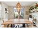 Inviting dining area with a large wooden table, stylish light fixture and patio access at 10220 E Isleta Ave, Mesa, AZ 85209