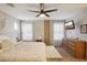 Bright main bedroom featuring a ceiling fan, modern decor and natural light for a relaxing space at 10220 E Isleta Ave, Mesa, AZ 85209