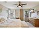 Comfortable main bedroom with a ceiling fan, natural light and desert views creates a calming environment at 10220 E Isleta Ave, Mesa, AZ 85209