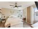 Bright main bedroom with a ceiling fan, lots of natural light and neutral decor elements at 10220 E Isleta Ave, Mesa, AZ 85209