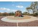 Community playground featuring a slide, climbing structure, and circular walkway on a sunny day at 10220 E Isleta Ave, Mesa, AZ 85209