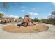 Community playground featuring climbing structures and a slide in a safe, sandy play area at 10220 E Isleta Ave, Mesa, AZ 85209