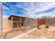 Enclosed area in backyard ideal for pet or garden, secured by metal and brick fencing at 11856 W Grant St, Avondale, AZ 85323
