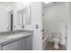 A modern bathroom with a granite countertop and a shower and bath combination at 11856 W Grant St, Avondale, AZ 85323