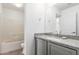 Bathroom with granite countertops, modern fixtures, and bath with shower at 11856 W Grant St, Avondale, AZ 85323