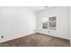 Neutral bedroom with carpet and a window with white shutters letting in light at 11856 W Grant St, Avondale, AZ 85323