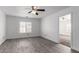 Light-filled bedroom with a ceiling fan and plantation shutters for optimal privacy at 11856 W Grant St, Avondale, AZ 85323