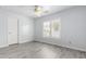 A clean bedroom has light gray walls and light wood flooring at 11856 W Grant St, Avondale, AZ 85323