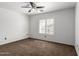 Bedroom features a window with shutters and neutral carpeting at 11856 W Grant St, Avondale, AZ 85323