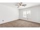 Cozy bedroom with shutters, a ceiling fan and carpet floors at 11856 W Grant St, Avondale, AZ 85323