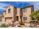 Two-story home displaying a two-car garage, desert landscaping, and an angel water fountain at 11856 W Grant St, Avondale, AZ 85323