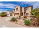 A two-story home with a three-car garage, front yard desert landscaping, and a water fountain at 11856 W Grant St, Avondale, AZ 85323