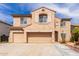 Charming two-story house showcasing a three-car garage and desert landscaping at 11856 W Grant St, Avondale, AZ 85323