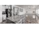 Kitchen with granite counters, a granite island, and stainless steel appliances at 11856 W Grant St, Avondale, AZ 85323