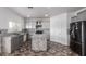 Well-lit kitchen featuring gray cabinets, subway tile backsplash, and granite island at 11856 W Grant St, Avondale, AZ 85323
