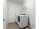 Bright laundry room featuring a washer and dryer and tile floors at 11856 W Grant St, Avondale, AZ 85323