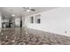 Spacious open-concept living area with decorative tile flooring and an adjoining kitchen at 11856 W Grant St, Avondale, AZ 85323
