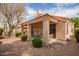 Covered back patio with outdoor seating surrounded by lush landscaping and a charming desert aesthetic at 12244 N Tower Dr, Fountain Hills, AZ 85268