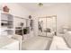 Bright bedroom featuring a custom built-in cabinet, mirrored closet, and comfortable seating area at 12244 N Tower Dr, Fountain Hills, AZ 85268