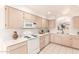 Well-lit kitchen featuring white appliances, ample cabinetry, and tile flooring at 12244 N Tower Dr, Fountain Hills, AZ 85268