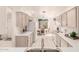 Bright kitchen features a dining area, white cabinetry, and ample counter space for cooking at 12244 N Tower Dr, Fountain Hills, AZ 85268