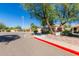 Exterior community parking and building in a desert environment with mature landscaping and trees at 12244 N Tower Dr, Fountain Hills, AZ 85268