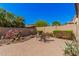 Large backyard featuring desert landscaping, a brick paver patio, and a seating area at 13641 W Jesse Red Dr, Peoria, AZ 85383
