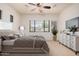 Bedroom with carpet flooring, a ceiling fan, and a large window with furniture in virtual staging at 13641 W Jesse Red Dr, Peoria, AZ 85383