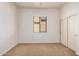 Bright, unfurnished bedroom with soft neutral carpeting, window with blinds and large closet with sliding doors at 13641 W Jesse Red Dr, Peoria, AZ 85383