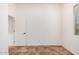 Bedroom with tiled floor, a window, door, base molding and light-colored walls at 13641 W Jesse Red Dr, Peoria, AZ 85383