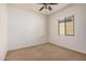 Cozy bedroom with neutral carpeting, window with blinds and ceiling fan at 13641 W Jesse Red Dr, Peoria, AZ 85383