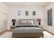 Virtually staged bedroom features a comfortable bed with side tables and lamps at 13641 W Jesse Red Dr, Peoria, AZ 85383