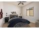 Stylishly staged bedroom with natural lighting, whale-shaped wall decoration, and soft, neutral carpeting at 13641 W Jesse Red Dr, Peoria, AZ 85383