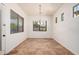 Bright dining room featuring tile floors, modern lighting, and natural light from three windows at 13641 W Jesse Red Dr, Peoria, AZ 85383