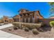 A single-Gathering home shows desert landscaping and a two car garage at 13641 W Jesse Red Dr, Peoria, AZ 85383
